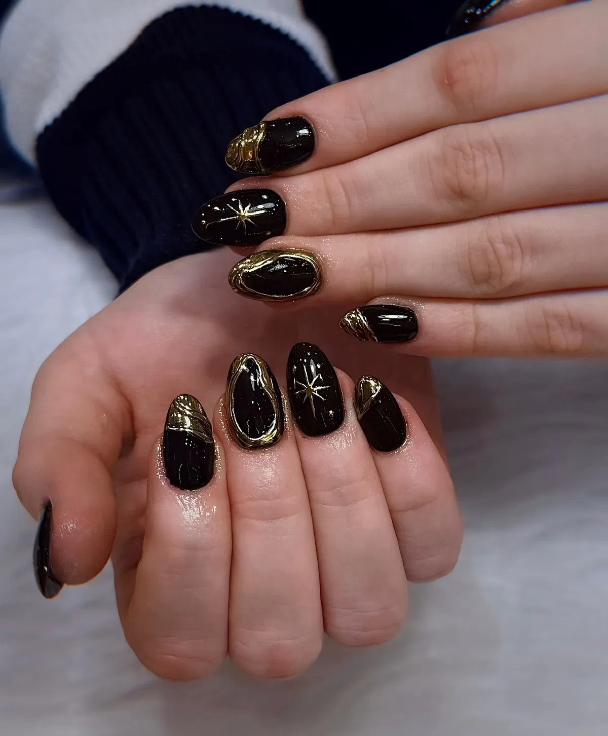 Glossy black with gold swirls and starbursts