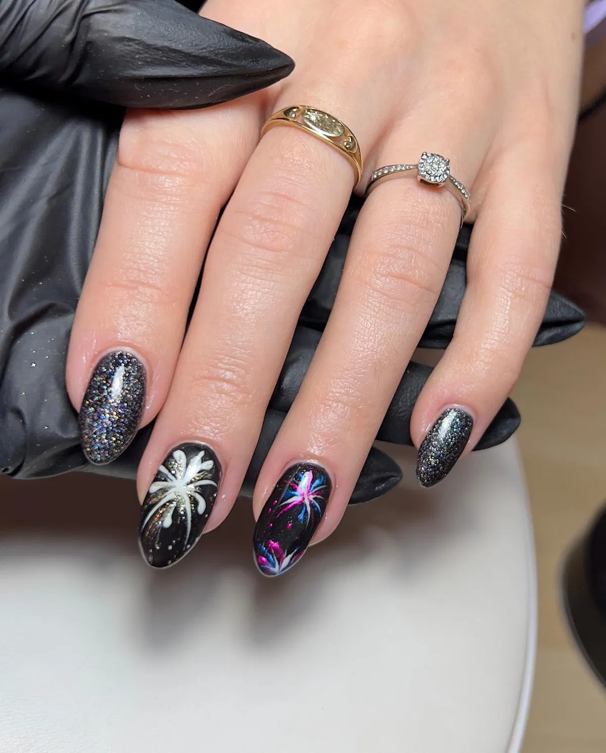 Black glitter and floral accent nails