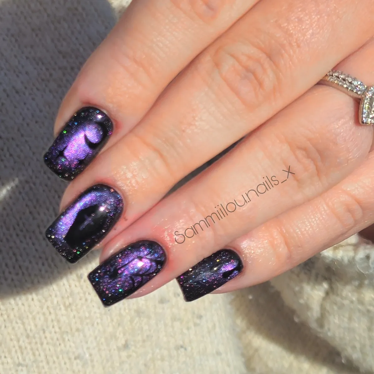 Dark glitter nails with purple-blue reflective sheen