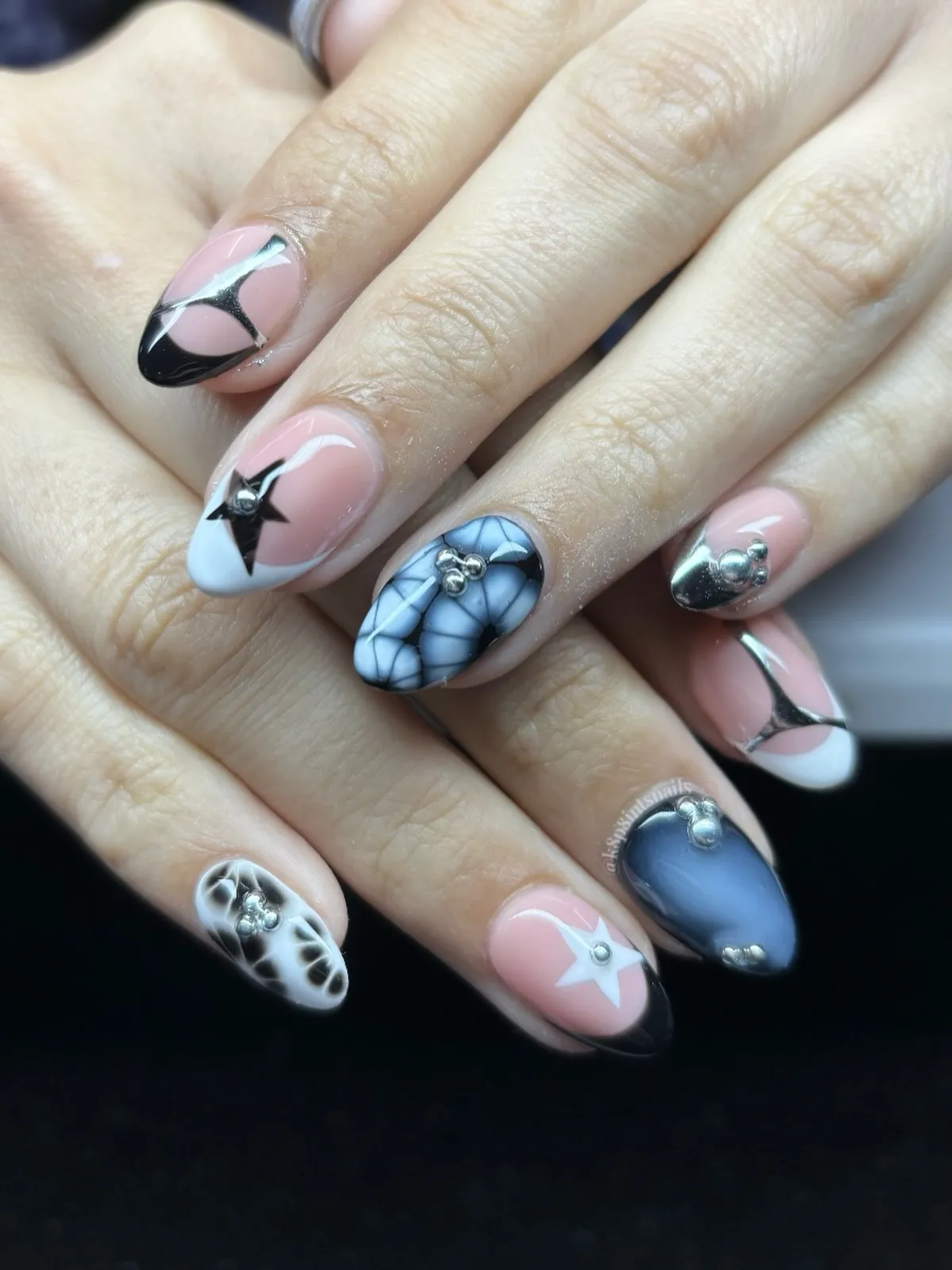 Black ombre tips with curved stripe-and-stud pattern