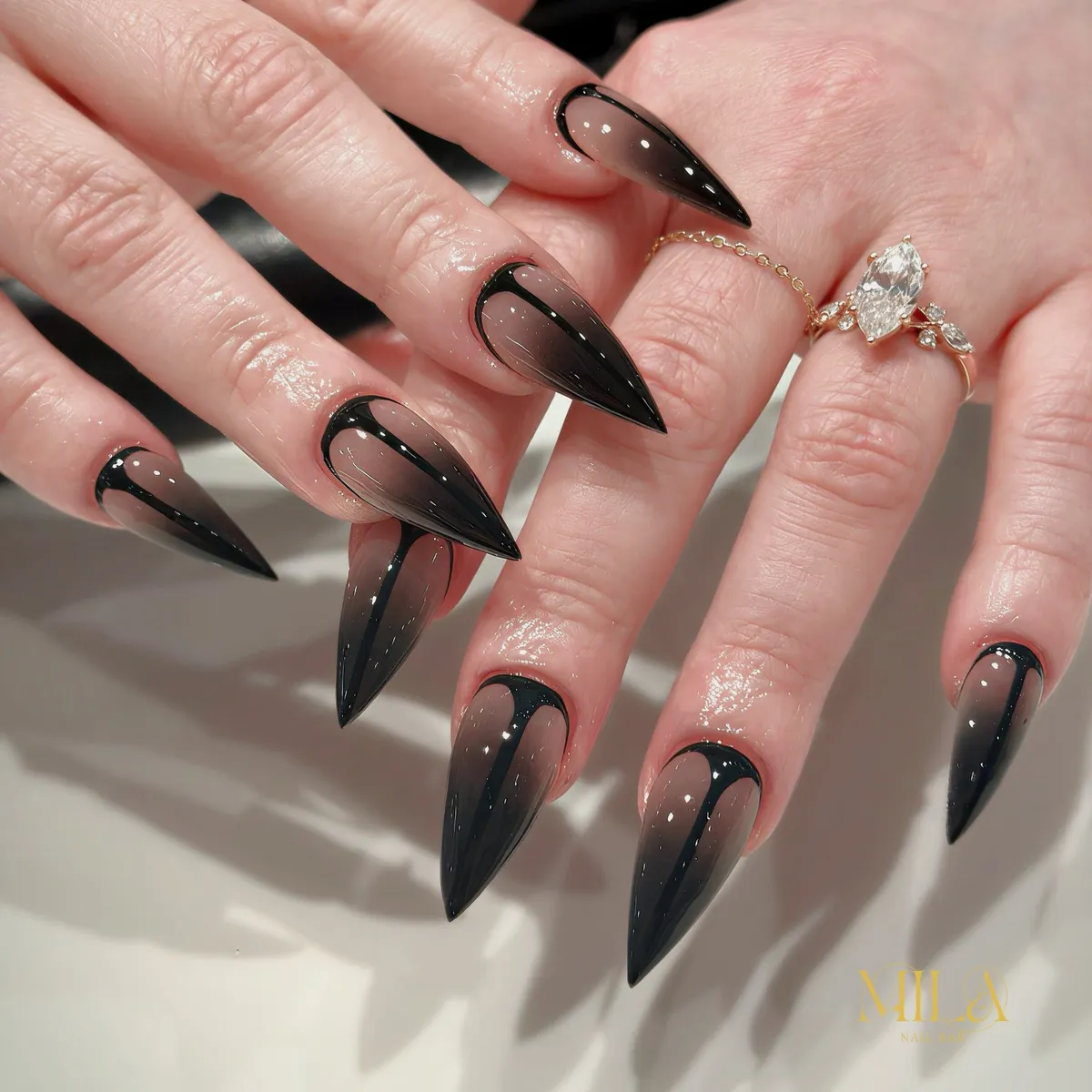 Sheer nude-to-black stiletto ombre with cuticle outline