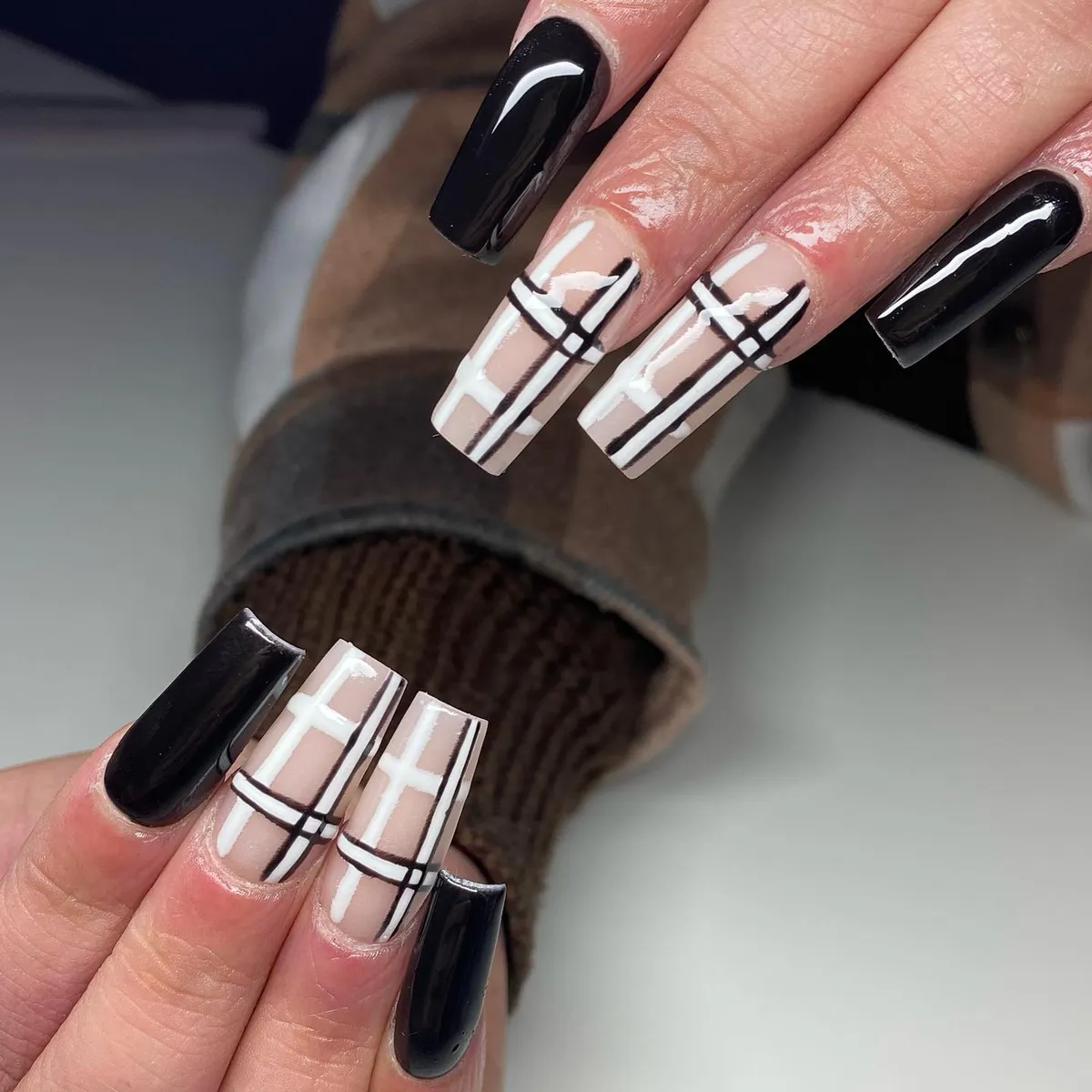 High-contrast nude plaid with white bands and black lines plus black solids