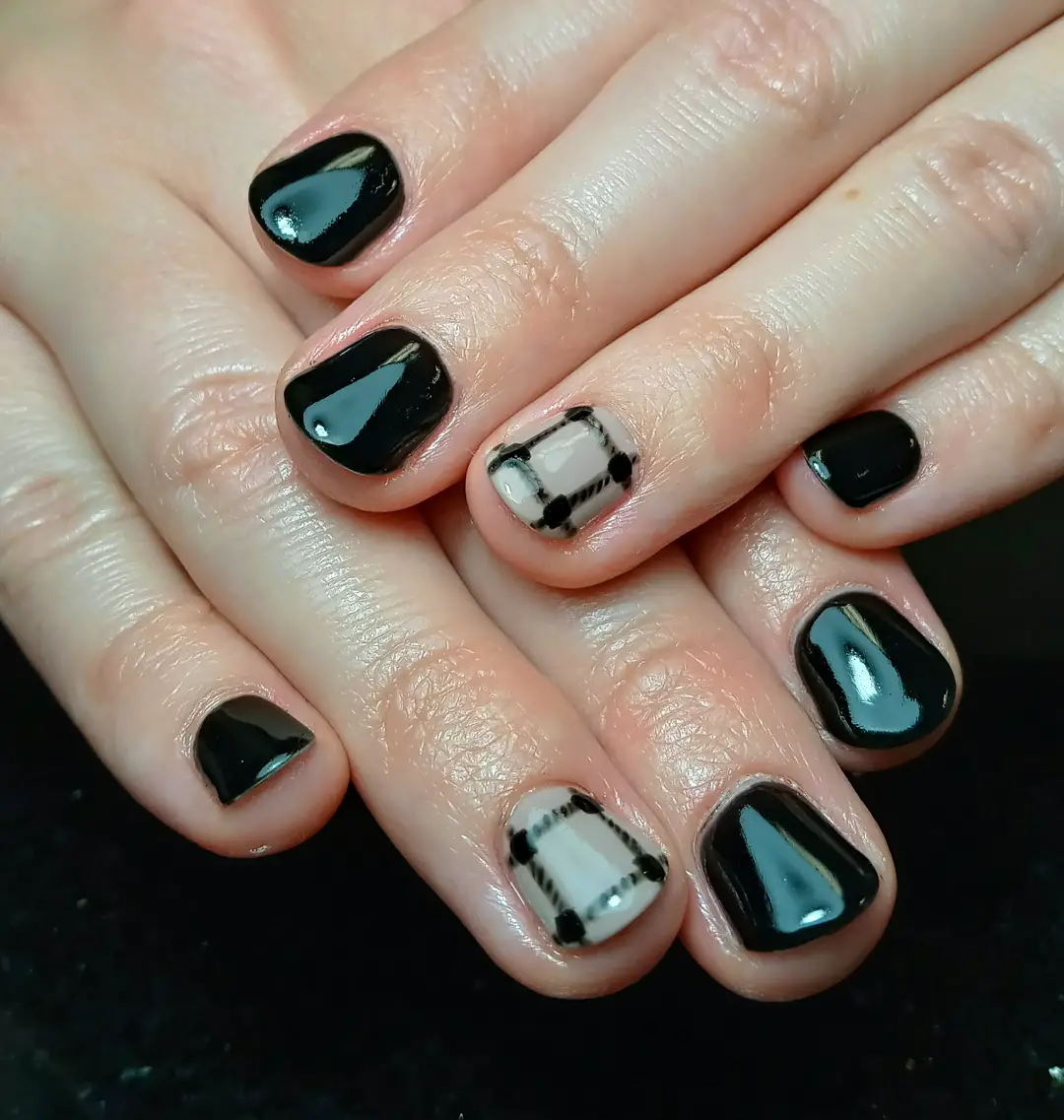 Glossy black nails with minimal framed plaid accents
