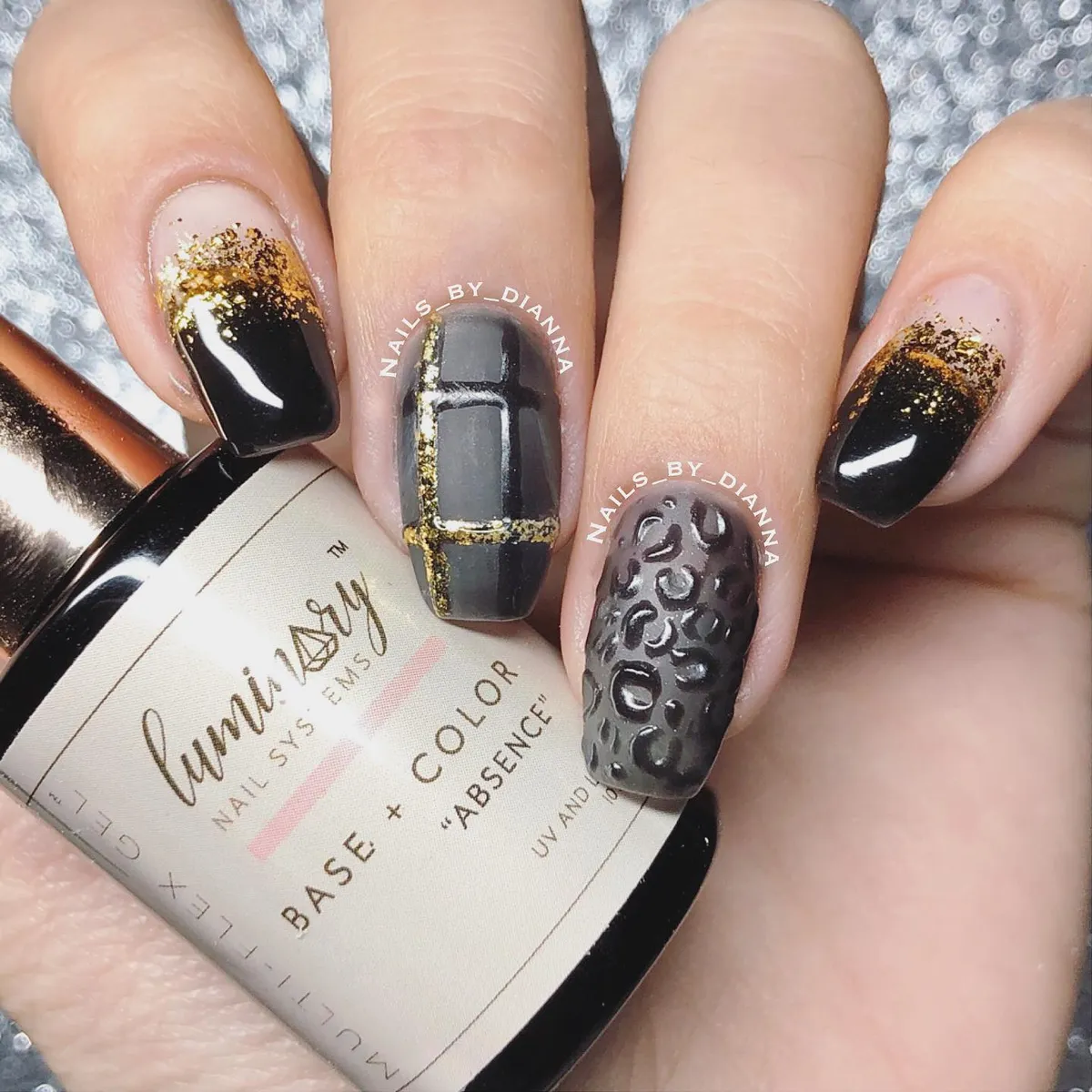 Black and gray plaid with gold glitter accents and raised texture nail