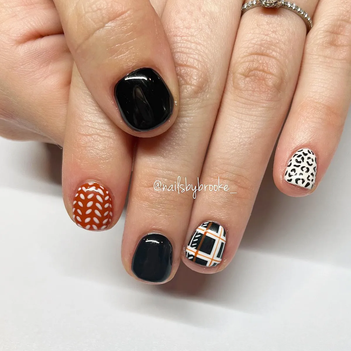 Mixed black solids with plaid accent and patterned nails