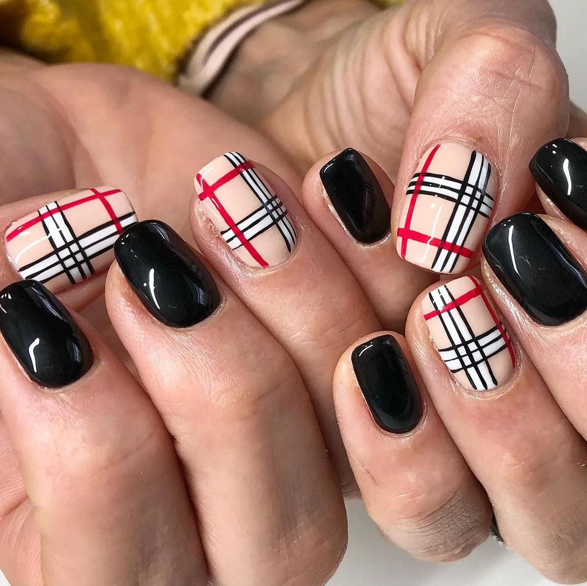 Beige plaid accents with red and black lines plus black solids