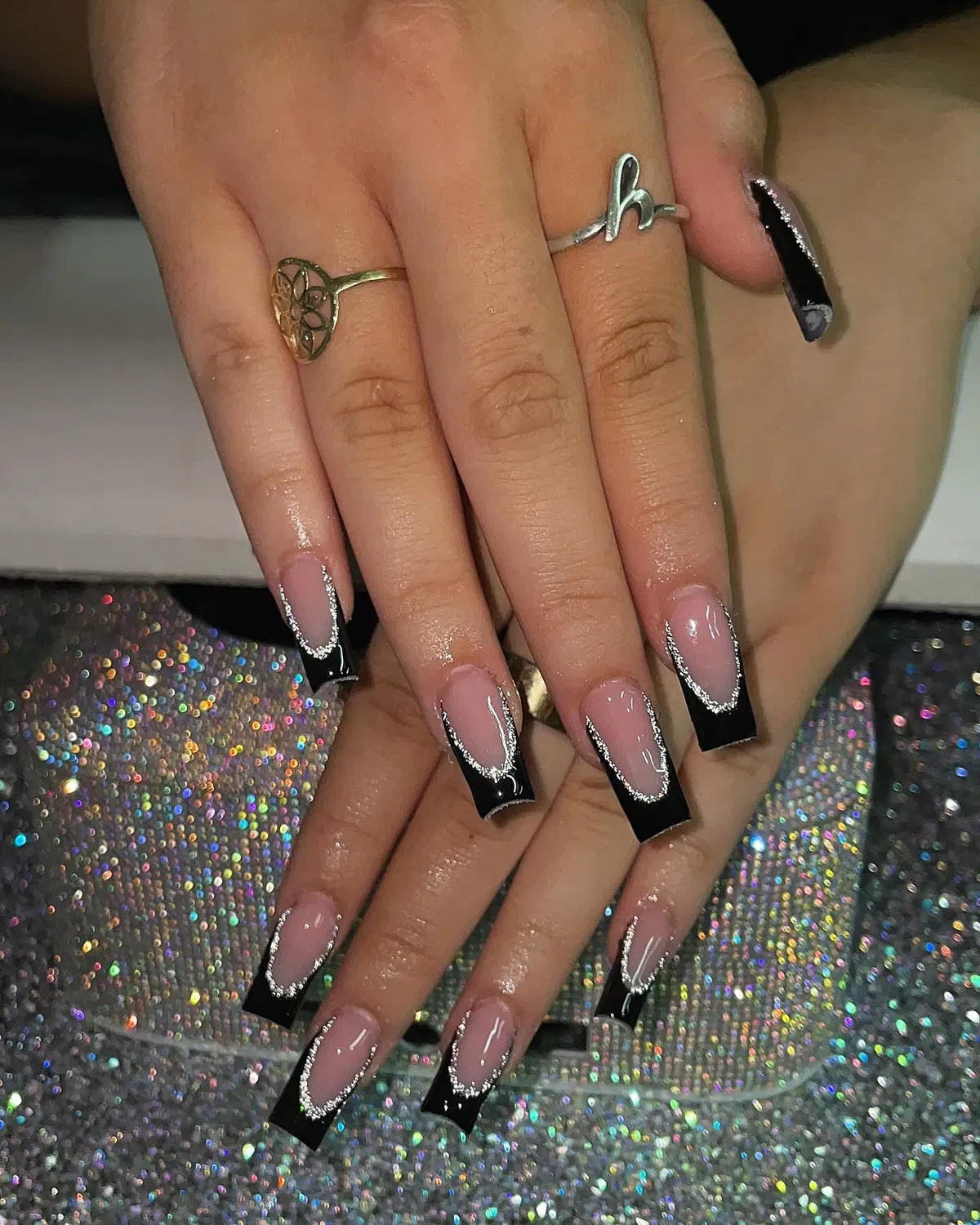 Black French tips edged with silver glitter outline