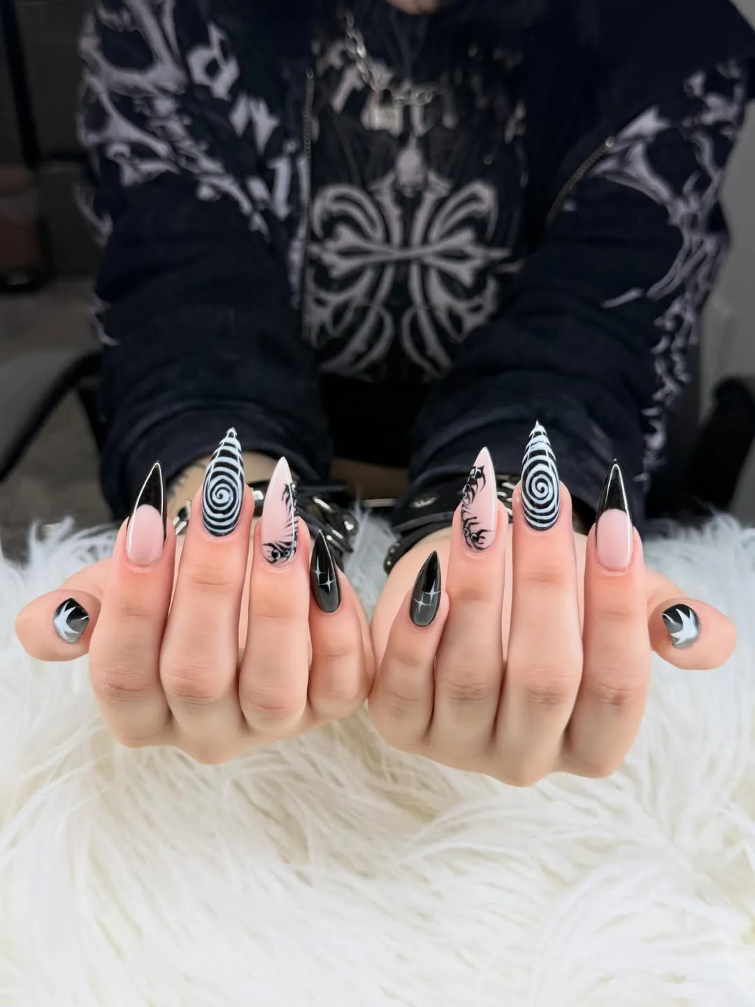 Black-and-nude stilettos with spiral accent nails