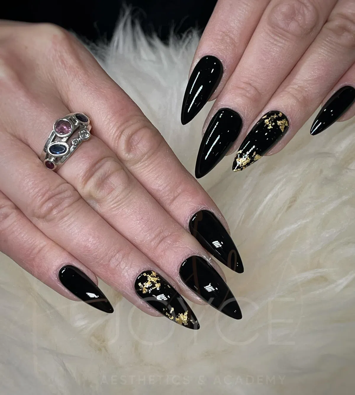 Glossy black stilettos with gold foil accents