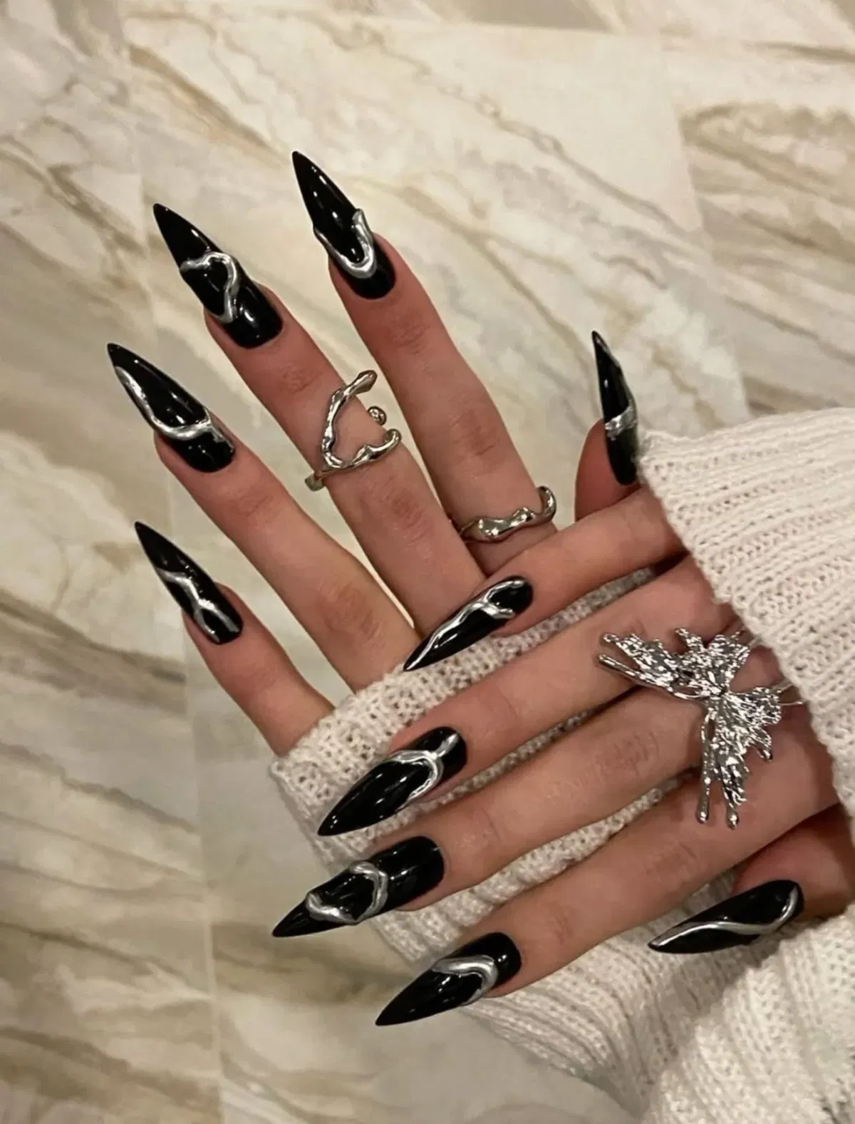 Glossy black stilettos with raised silver waves