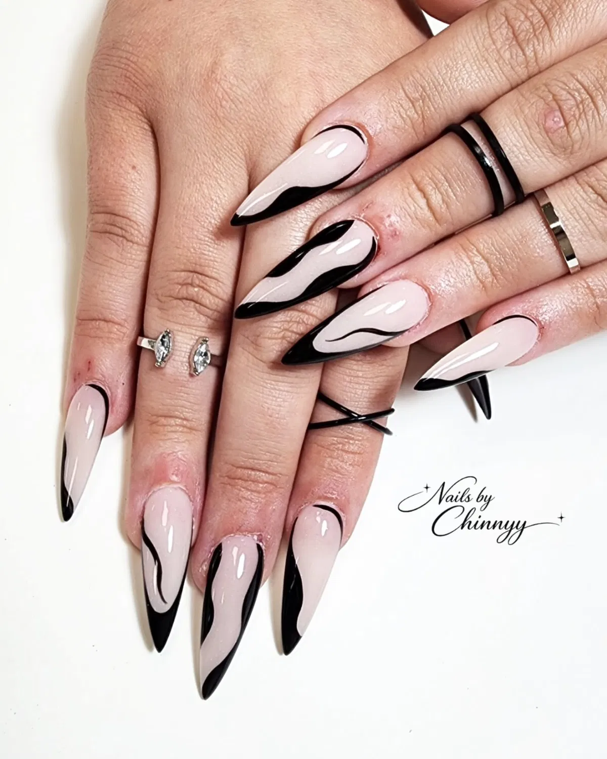 Pale nude stilettos with black wavy contour accents