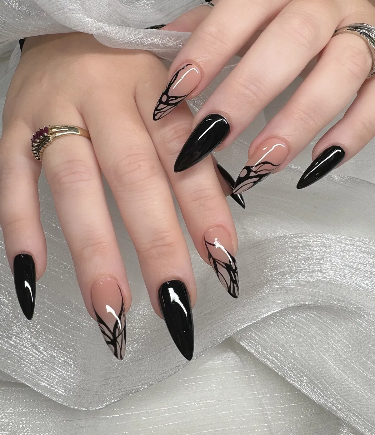 Glossy black solids with nude-and-black wing-like line art