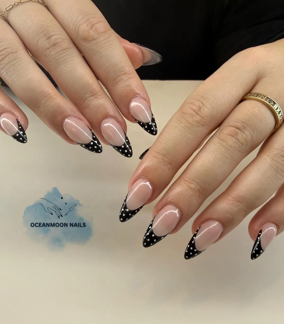 Polka-dot black French tips on almond nails