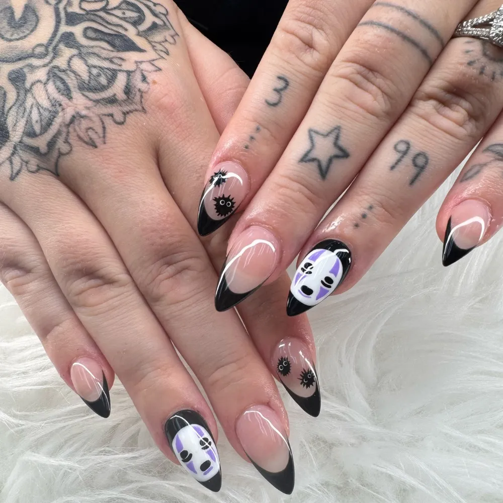 Almond black tips with white-and-purple face art accents