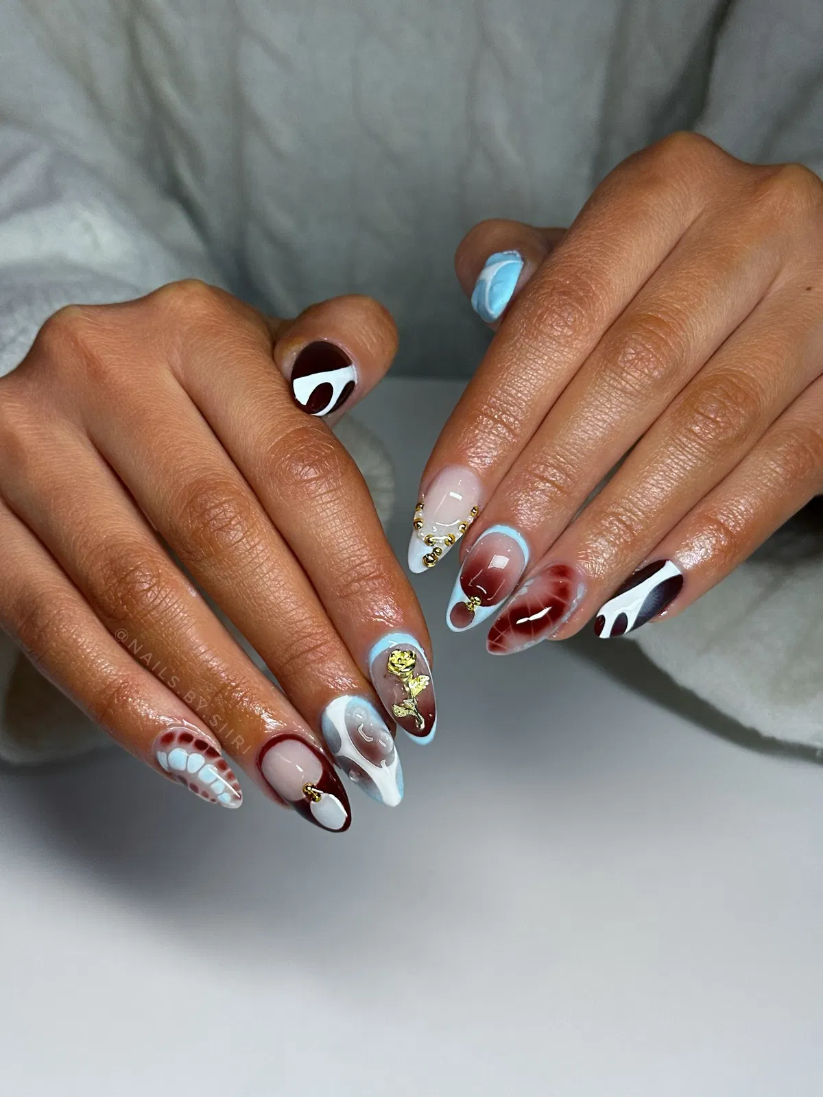 Abstract Swirl Nails with Light-Blue Details and Gold Accents