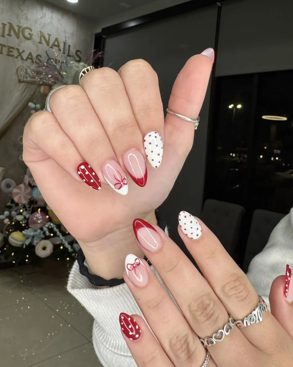 Red French tips with polka-dot and bow accents