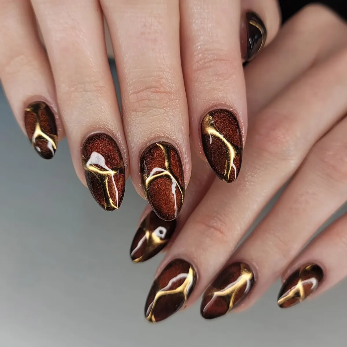 Shimmery Brown Nails with Abstract Gold Linework