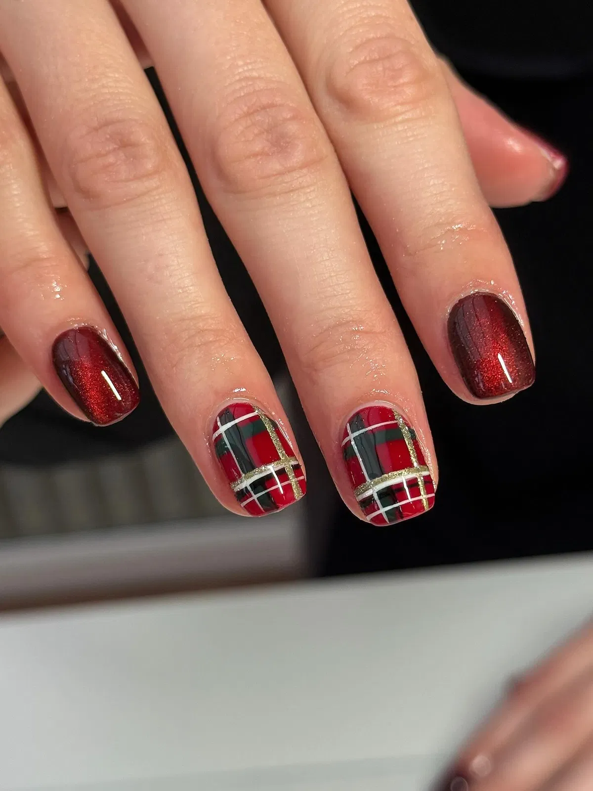 Shimmery deep red with tartan plaid accent nails