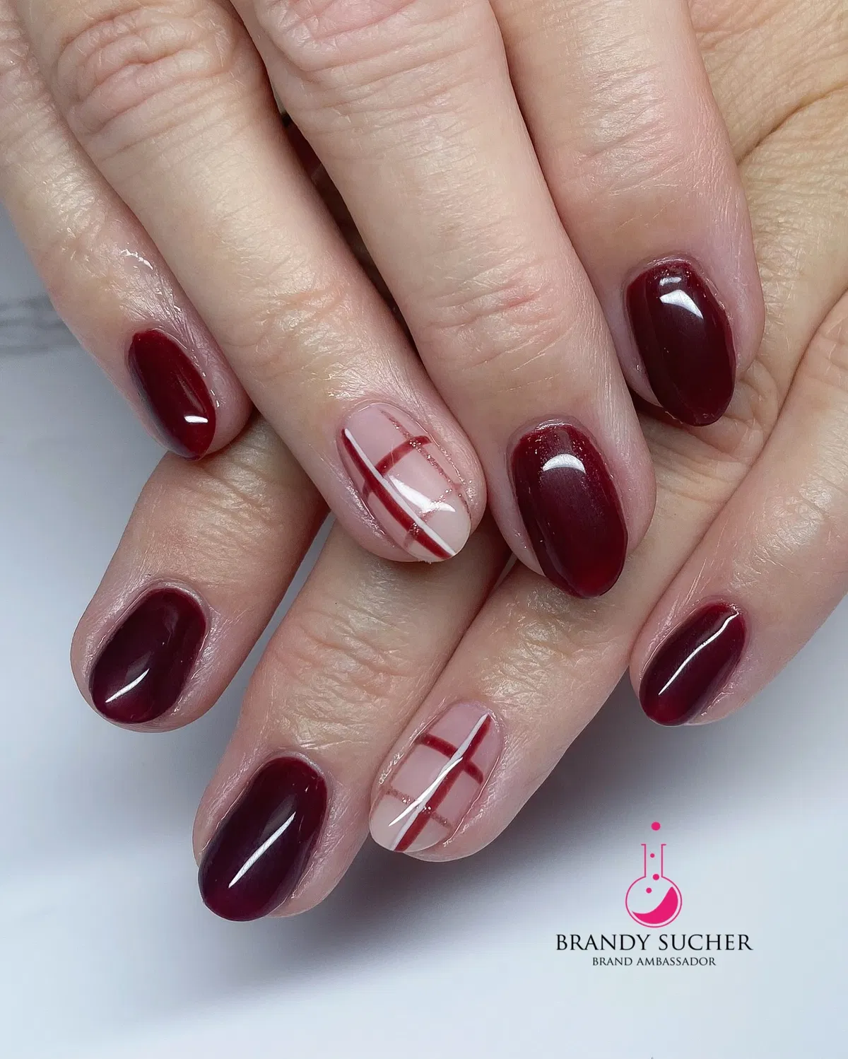 Deep burgundy gloss with minimal pale pink plaid accents
