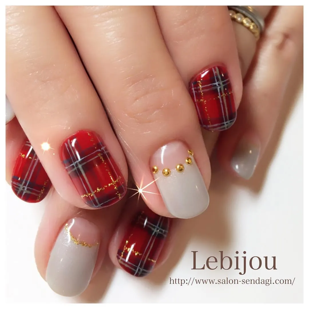 Red plaid with gray lines, gold accents, and studded cuticles