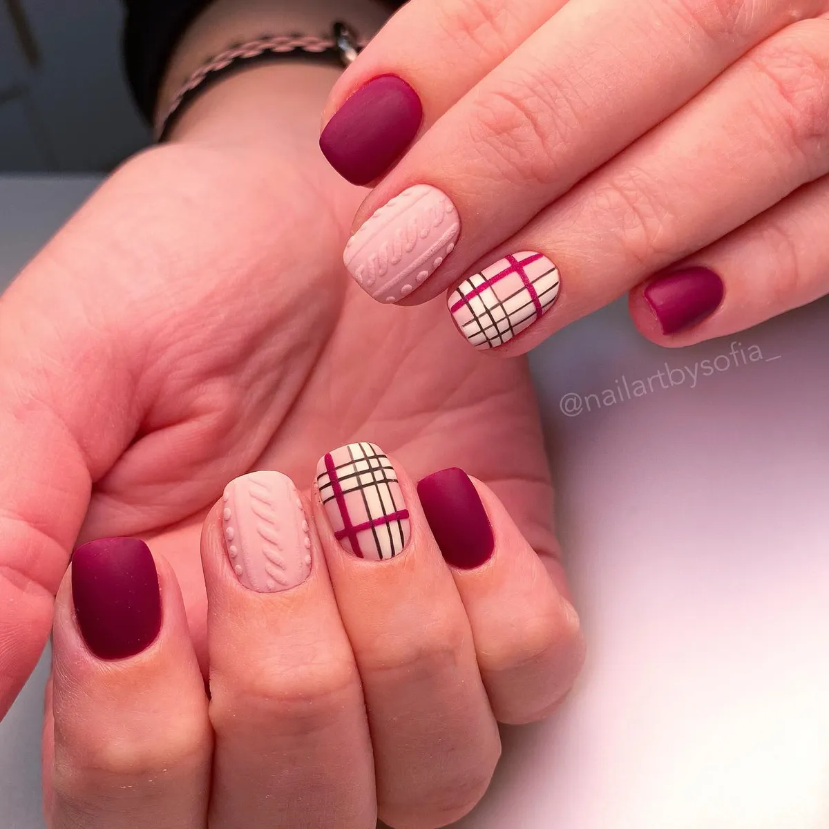 Matte burgundy with beige plaid and raised knit-style accents