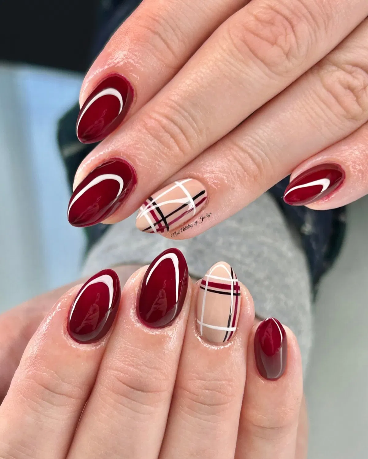 Deep red swoosh nails with nude plaid accent nails