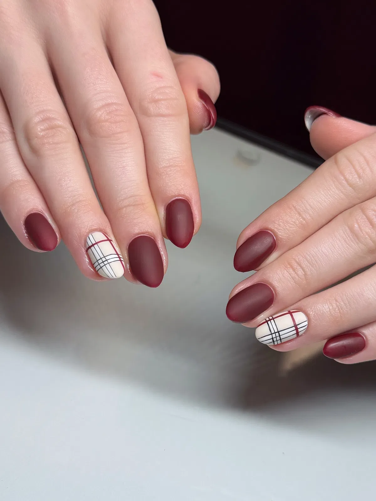 Matte burgundy set with off-white plaid accent nails