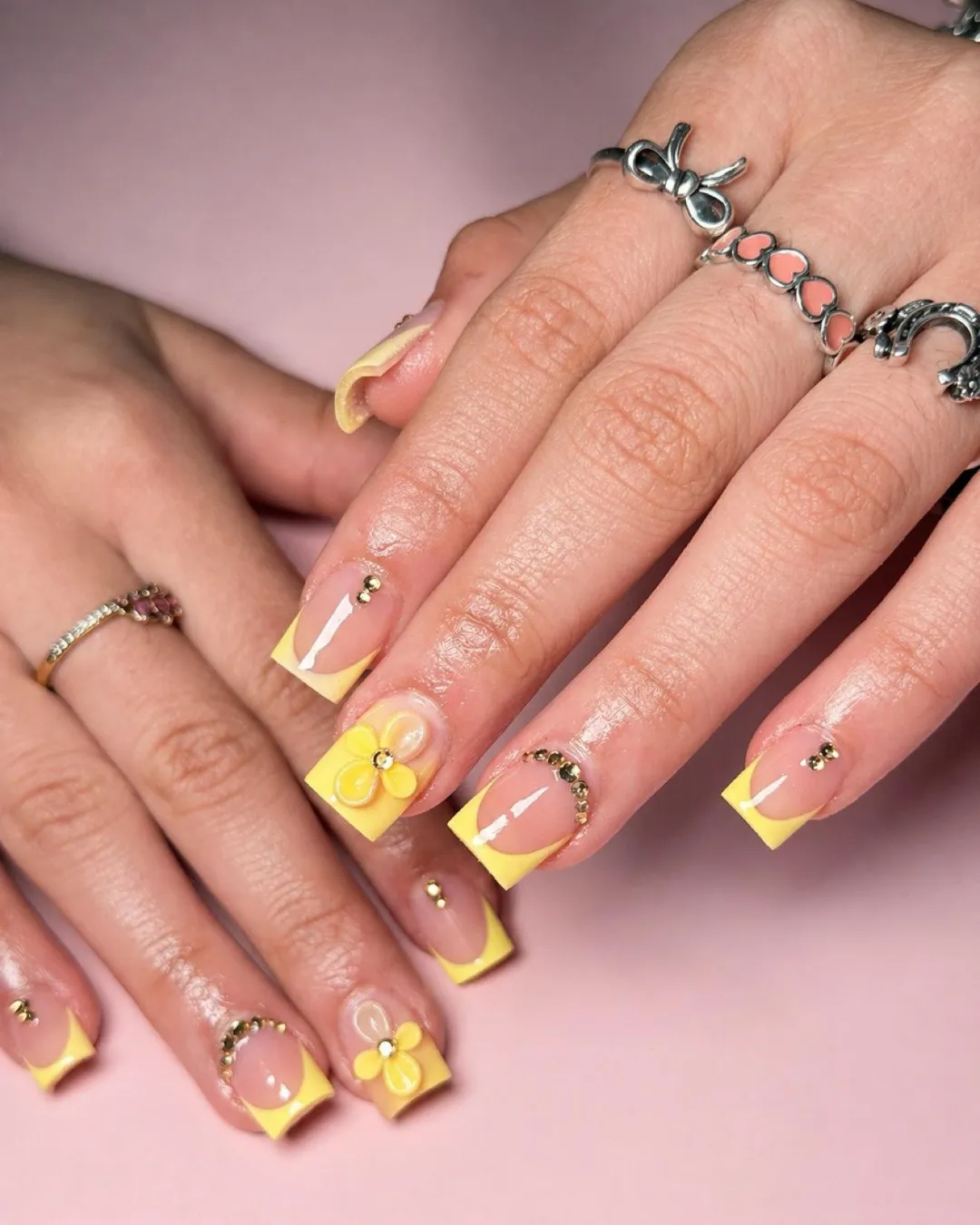 Square yellow French tips with gold studs and 3D flowers