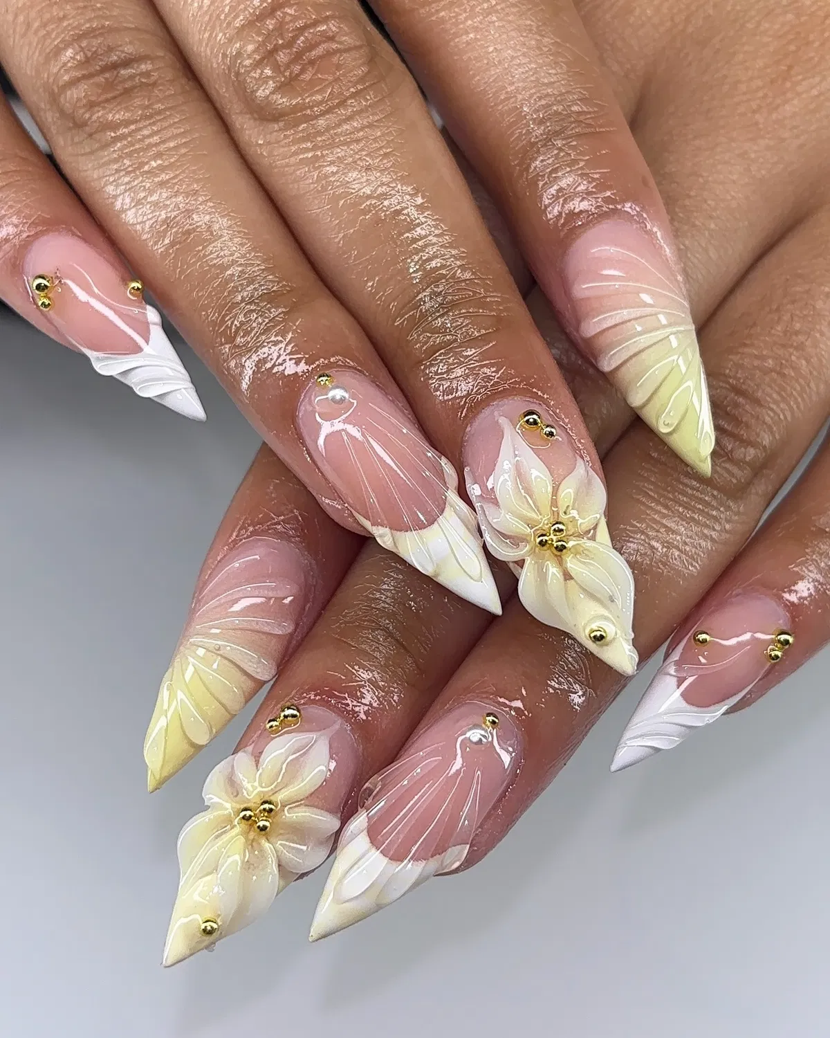Pointed nude base with white/yellow raised florals and gold beads
