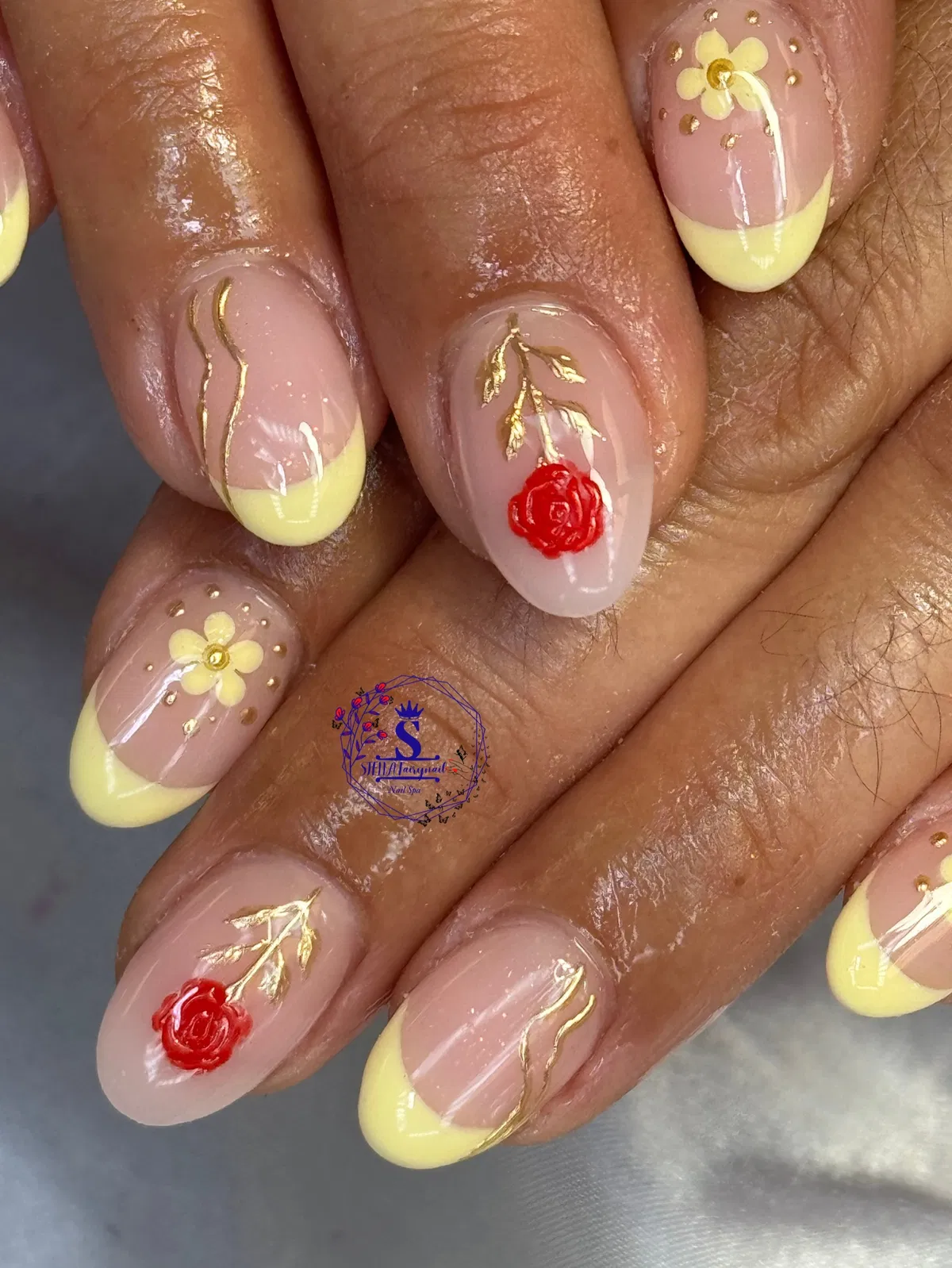 Yellow French tips with gold line art and red rose accents