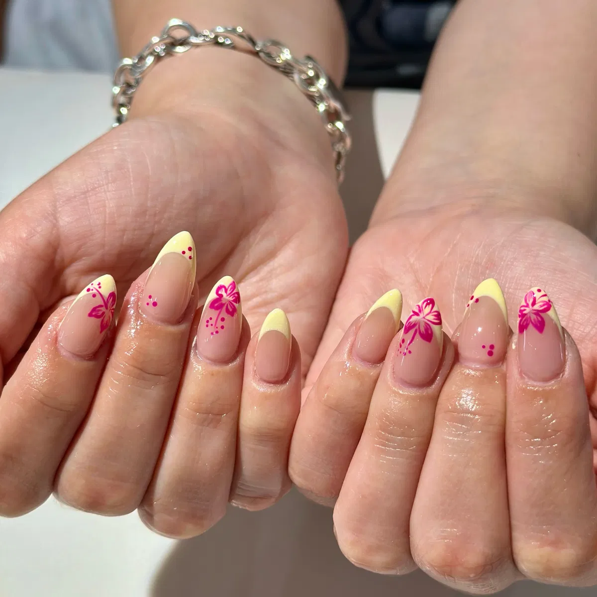 Yellow French tips with hot pink floral details
