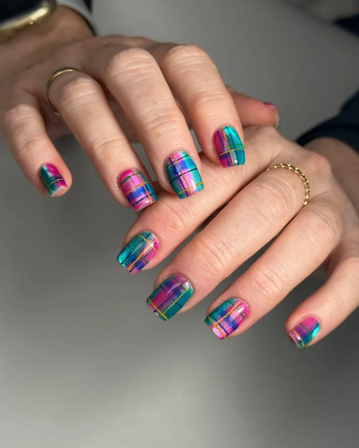 Bright multicolor plaid grid on short square nails