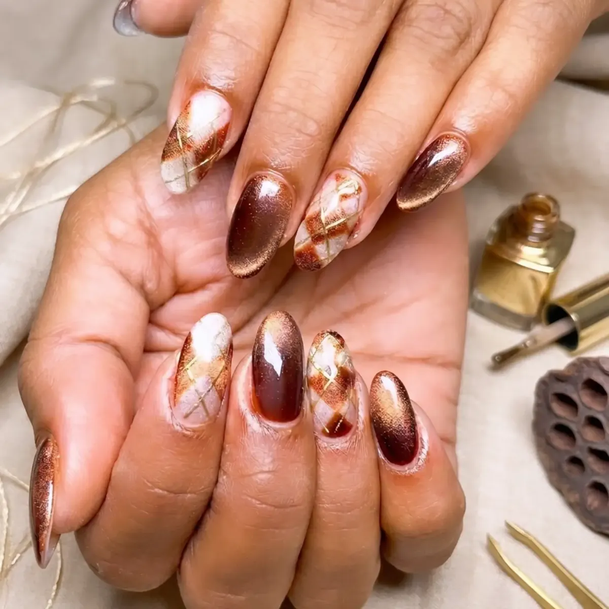 Bronze shimmer almonds with diagonal plaid/diamond-grid accents