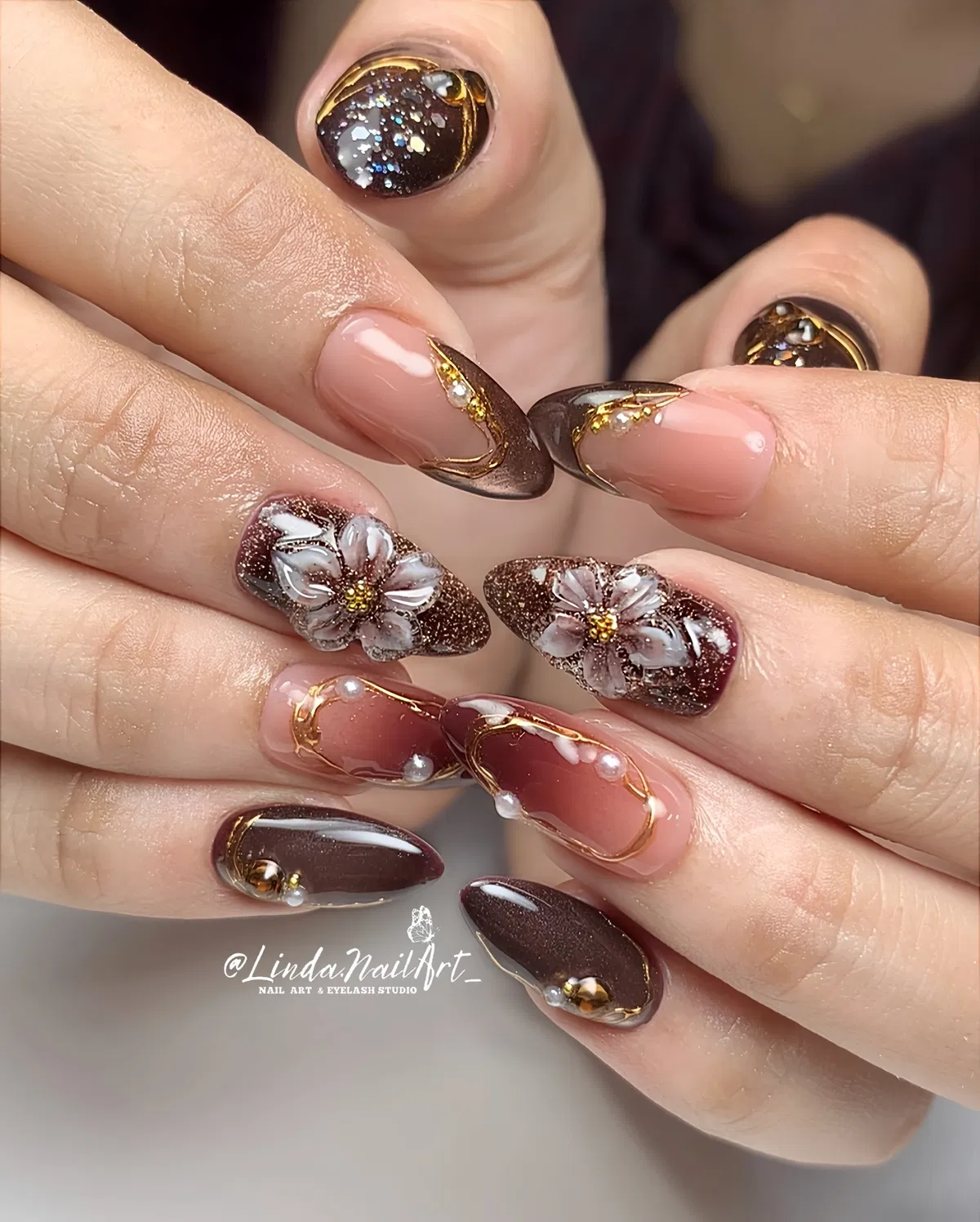 Brown glitter and nude nails with gold outlines and 3D flowers