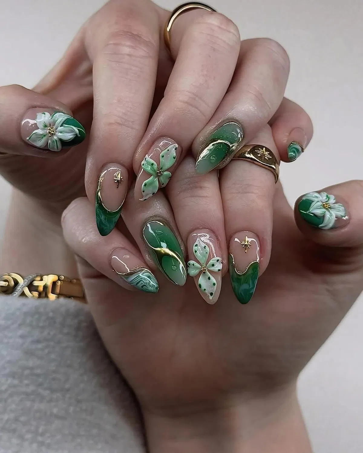 Green French tips with raised flowers, bows, and gold accents