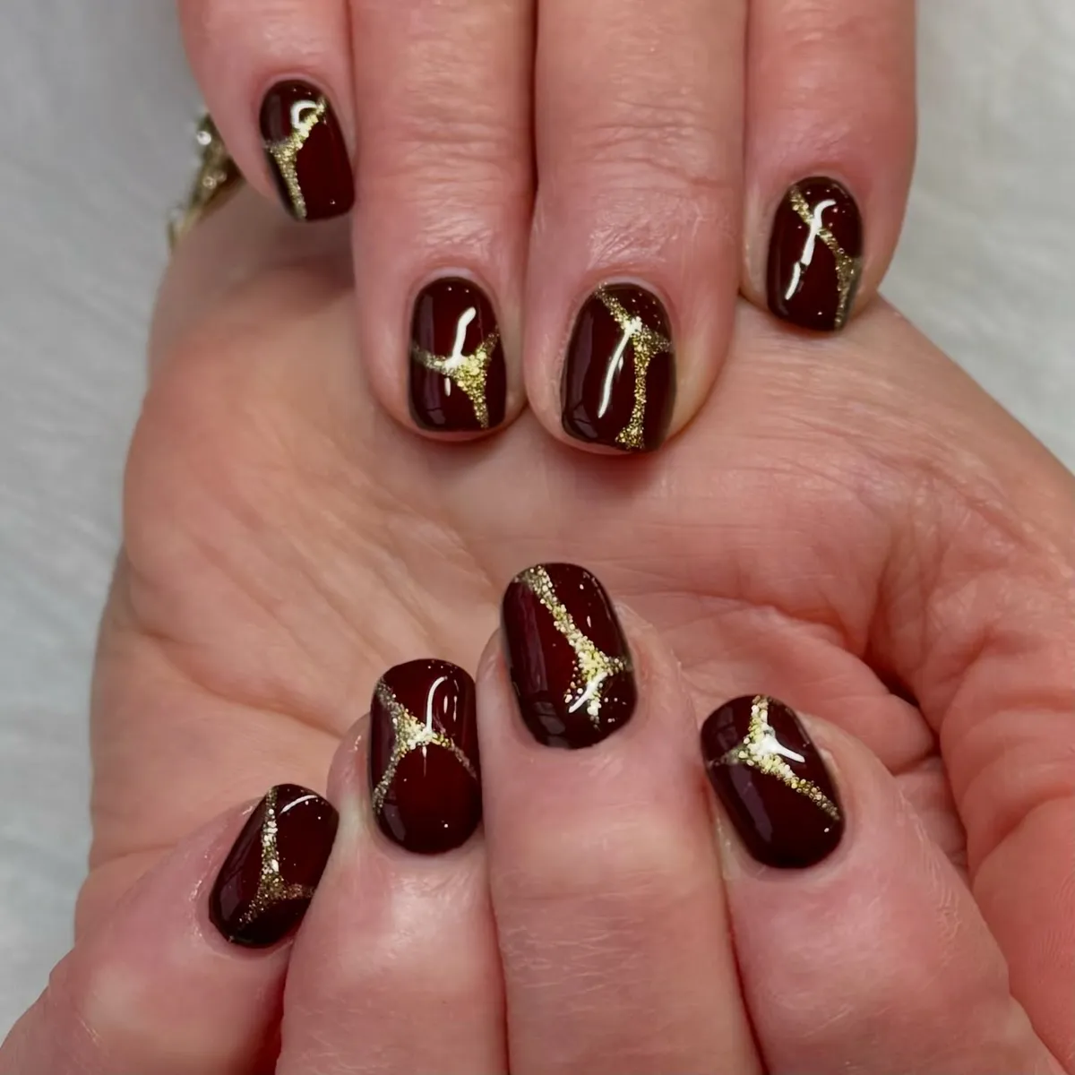 Deep burgundy with sweeping gold glitter curves