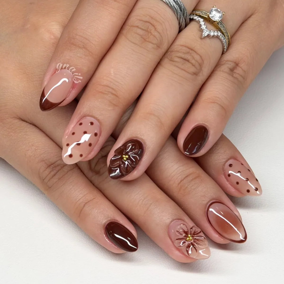 Brown French tips and polka dots with glossy 3D floral accents