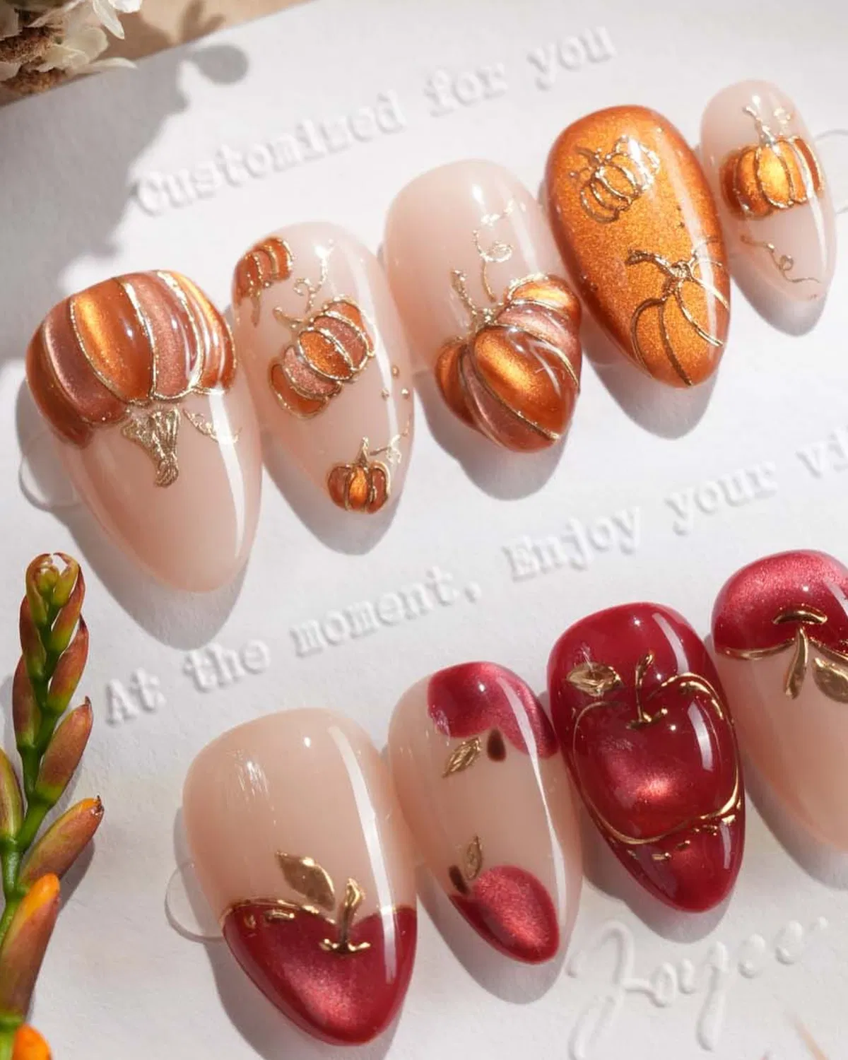 Pumpkin motifs in copper/orange and deep red with metallic line accents