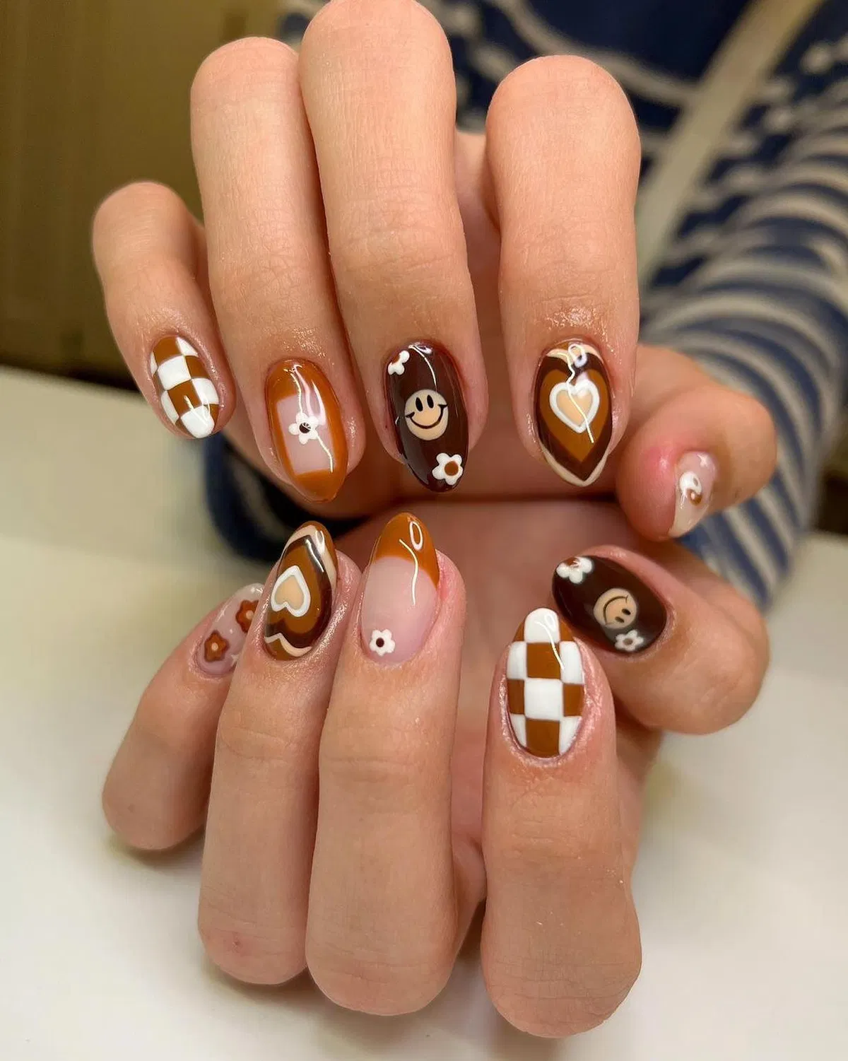 Checkerboard, hearts, and smiley motifs in browns