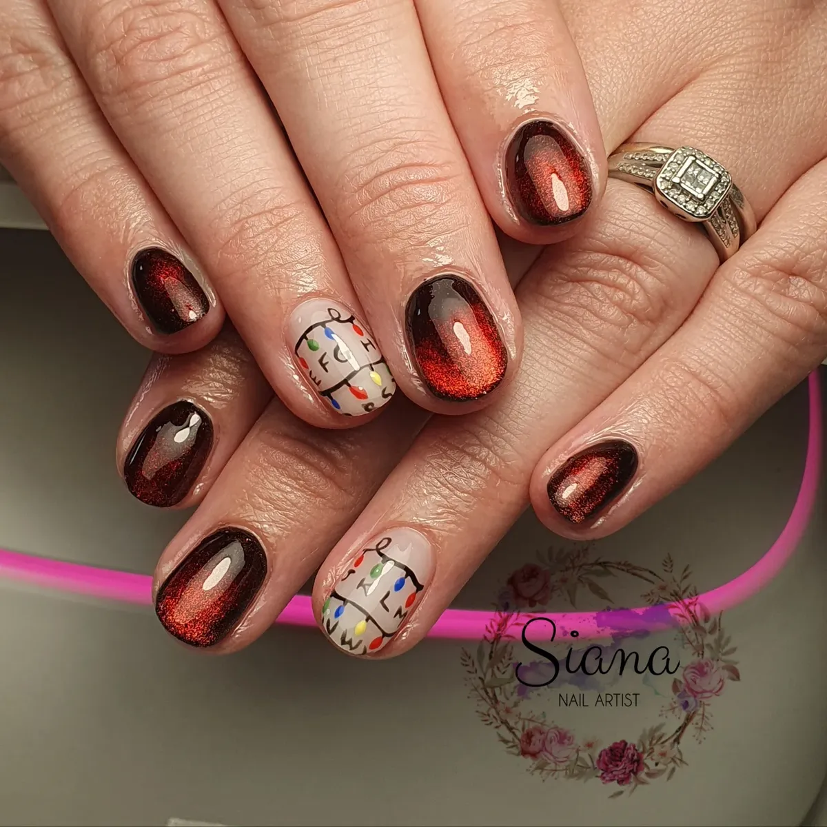 Dark red-glow nails with beige multicolor-dot accents