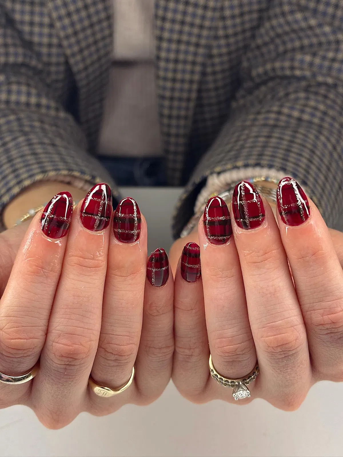 Deep red tartan-style nails with glitter grid lines