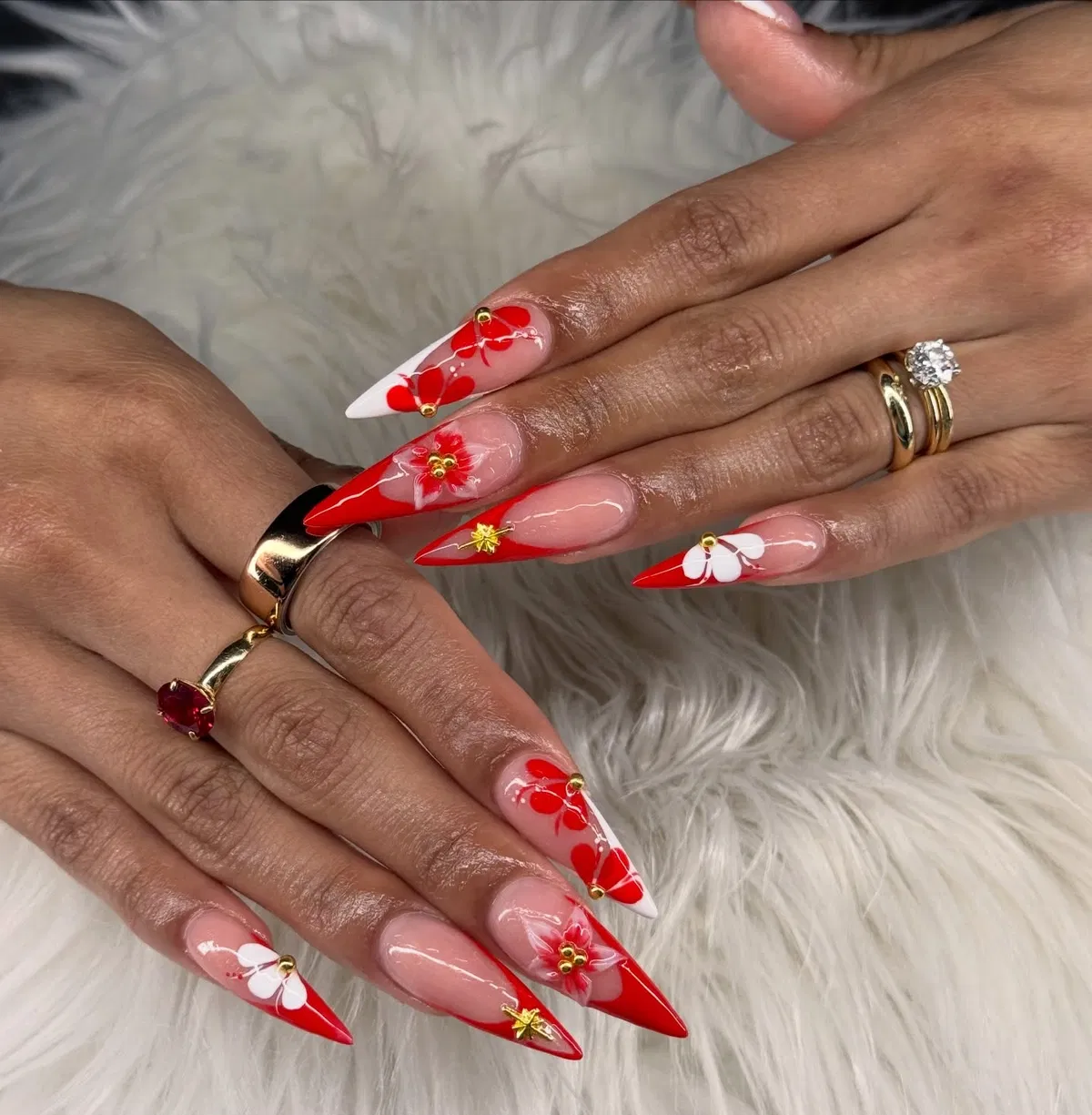 Stiletto French tips with floral details and gold accents