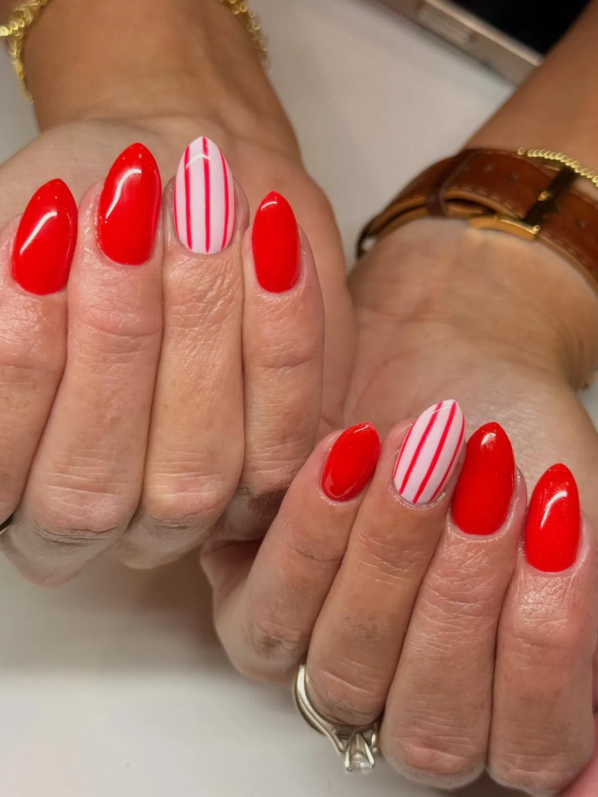 Glossy red with striped white accent nails