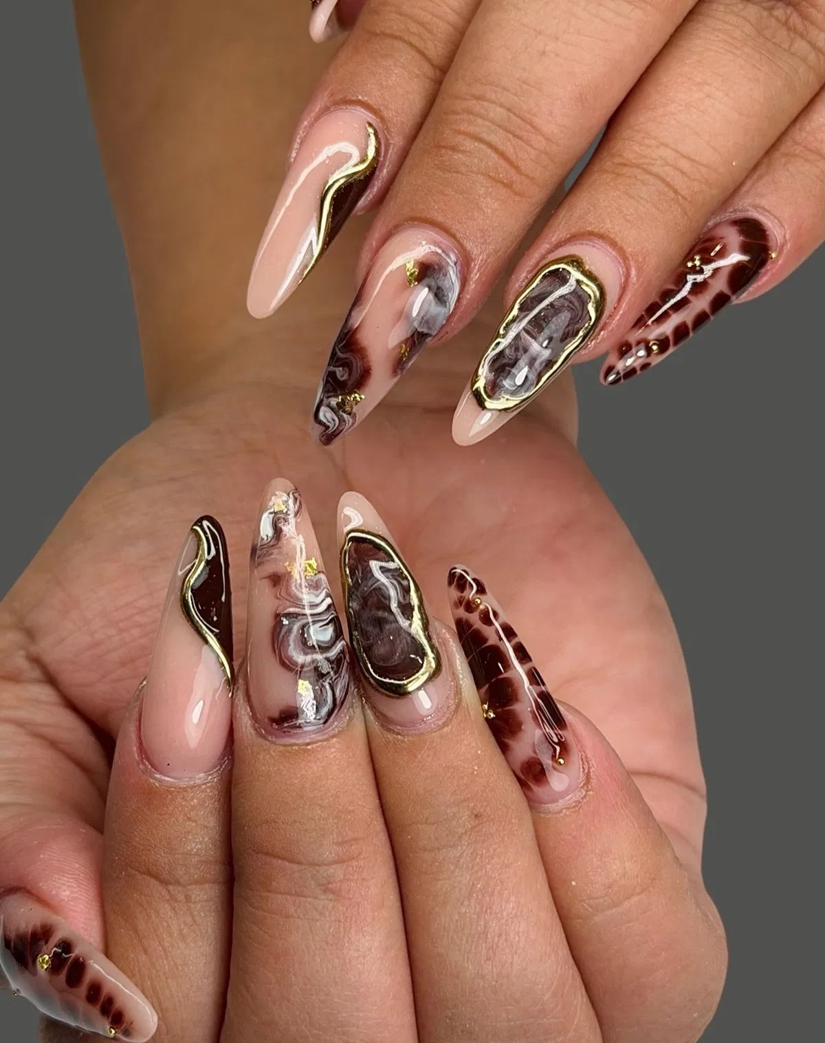 Marbled brown tones with gold framing and fleck accents