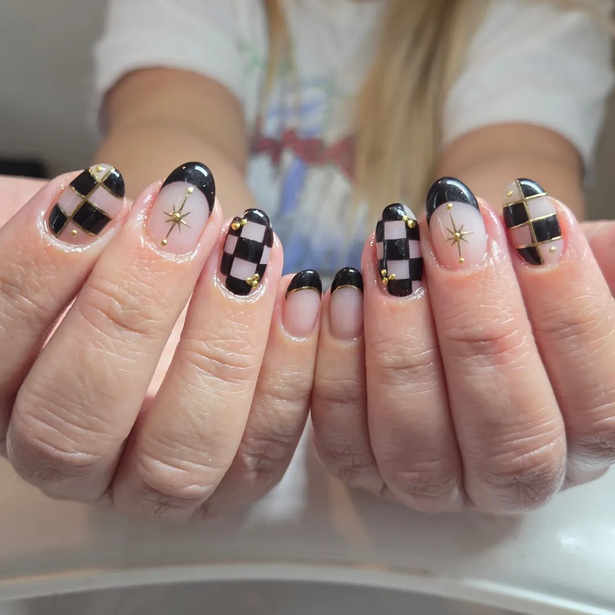 Short black-and-nude with gold grid, studs, and starbursts
