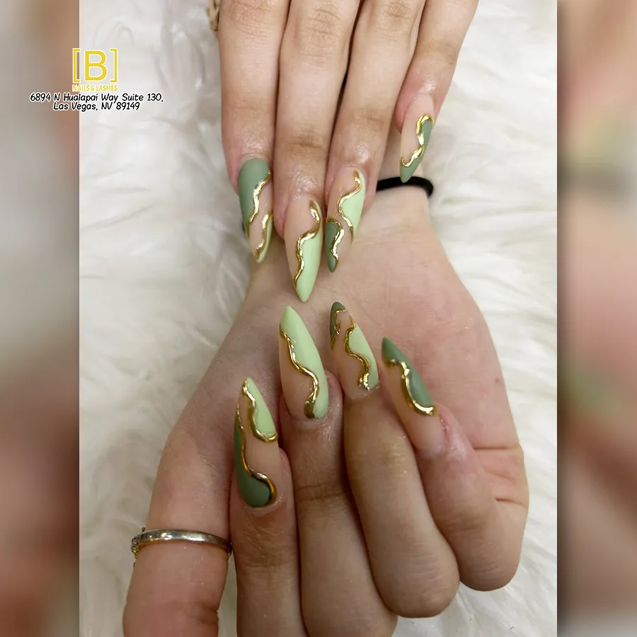 Light green and nude nails with raised gold wave lines