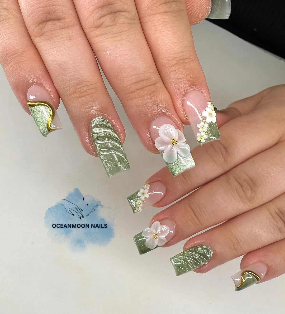 Pale green tips with raised white flowers and gold curves
