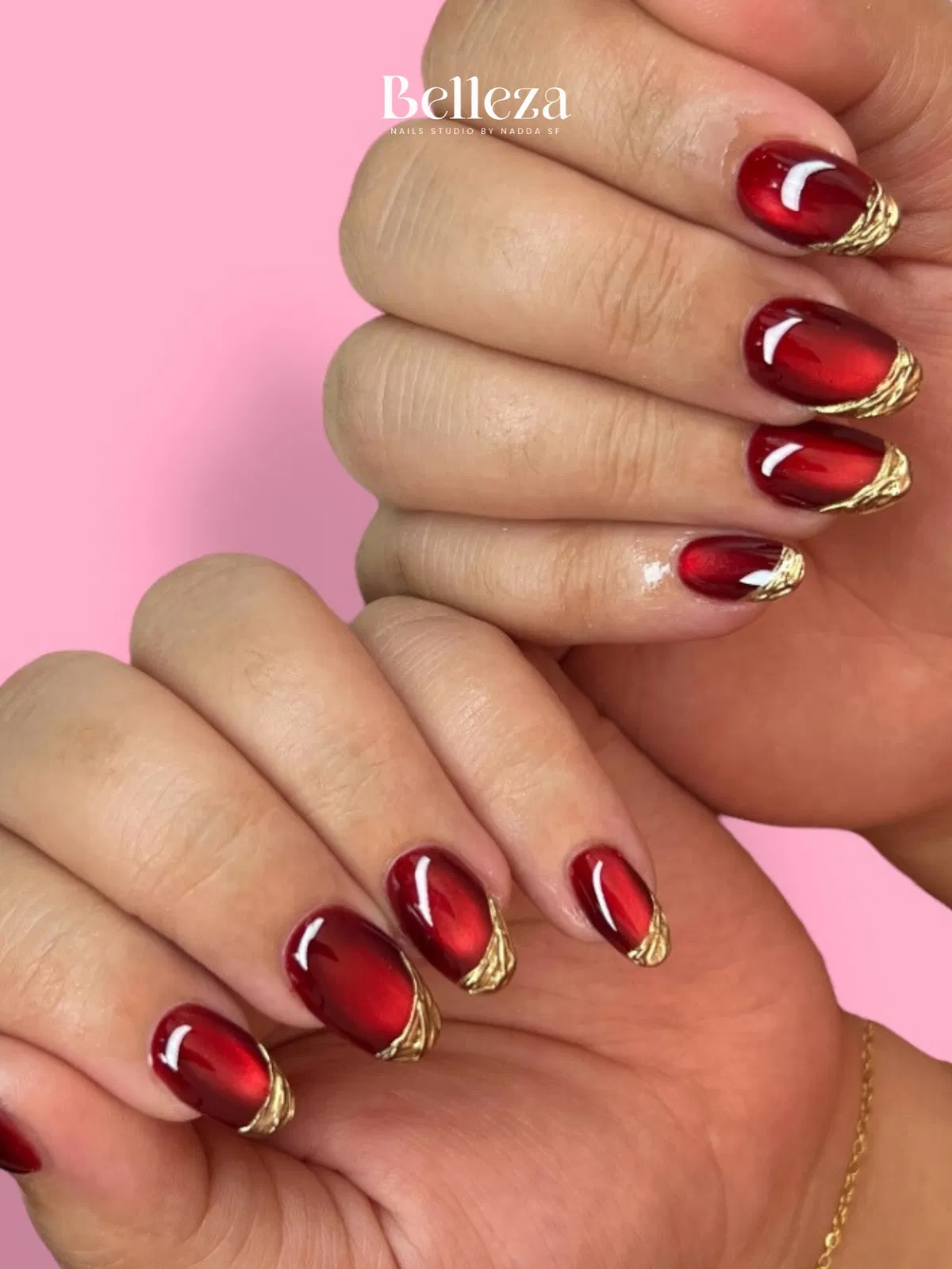 Short red gradient nails with raised gold tip accents