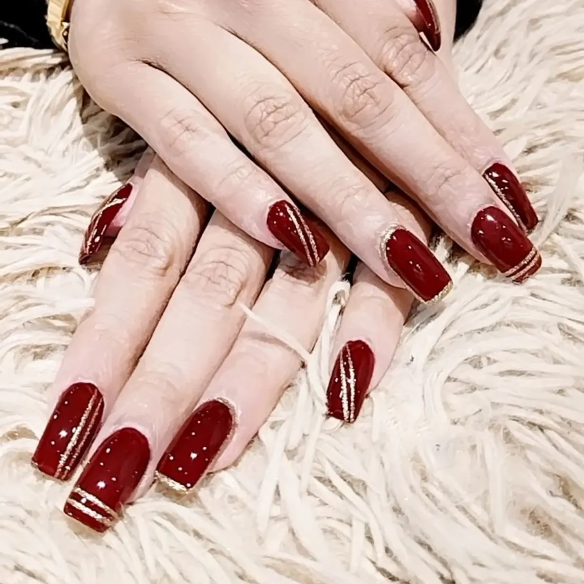 Glossy burgundy squares with thin gold striping