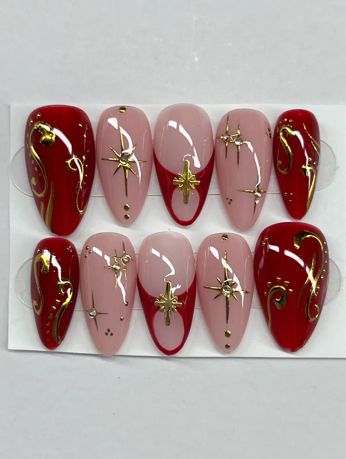 Deep red and nude set with gold swirls and starbursts